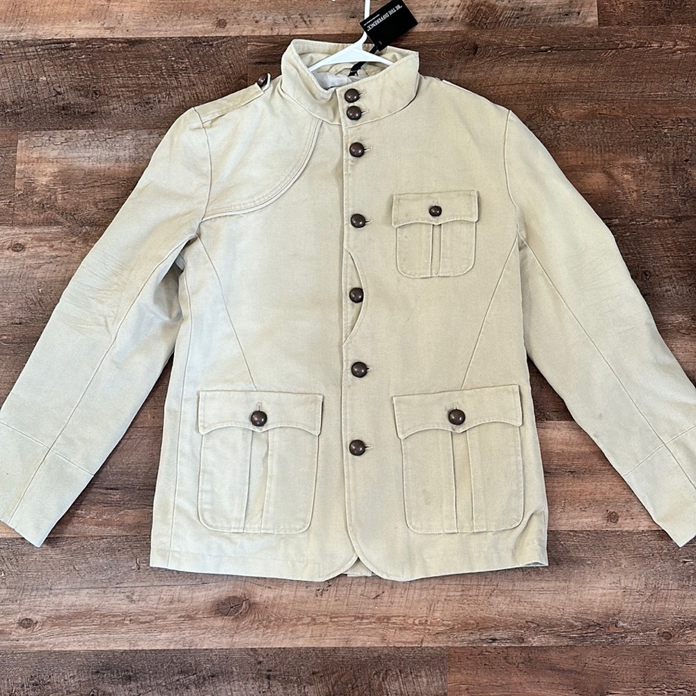Brand new cream colored Military jacket with buttons on the front and back.